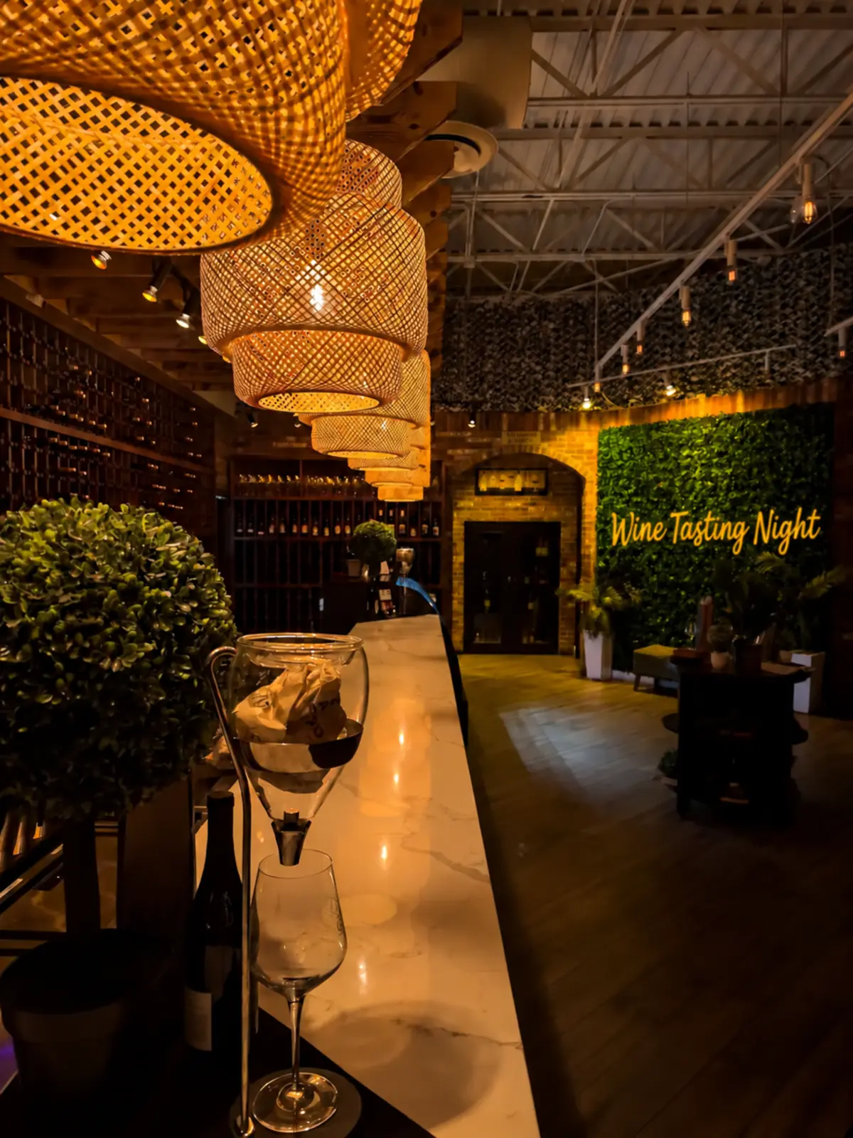 A warm wine venue interior with an illuminated Wine Tasting Night sign